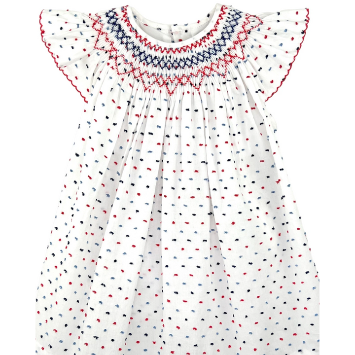 That Store smocked cotton bishop dress in white with red and blue dot pattern and angel wing sleeves