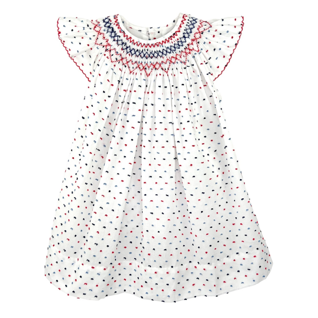 That Store smocked cotton bishop dress in white with red and blue dot pattern and angel wing sleeves