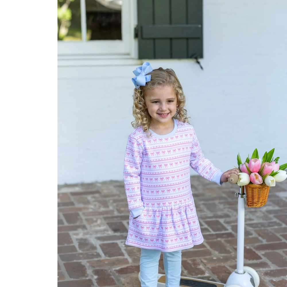 That Store sweetheart French terry tunic set with pink bow print on a girl with a blue hair bow and scooter