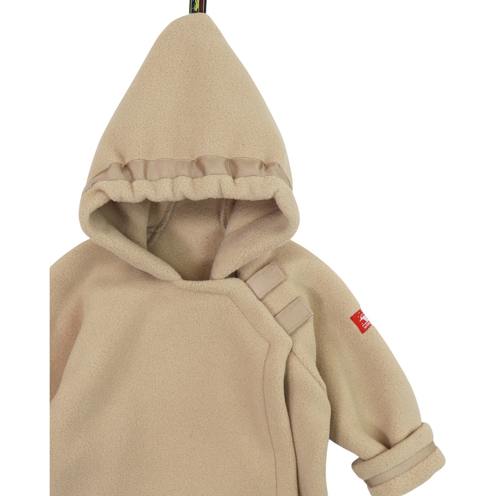 That Store tan Polartec fleece infant jacket with a hooded flap-over design and adjustable grosgrain ribbon detail.