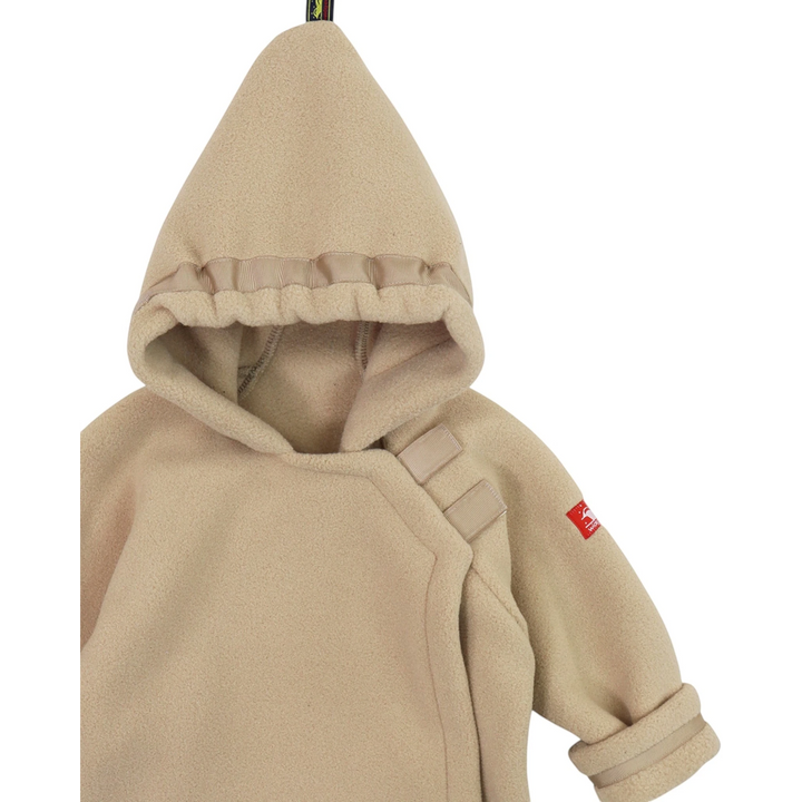 That Store tan Polartec fleece infant jacket with a hooded flap-over design and adjustable grosgrain ribbon detail.