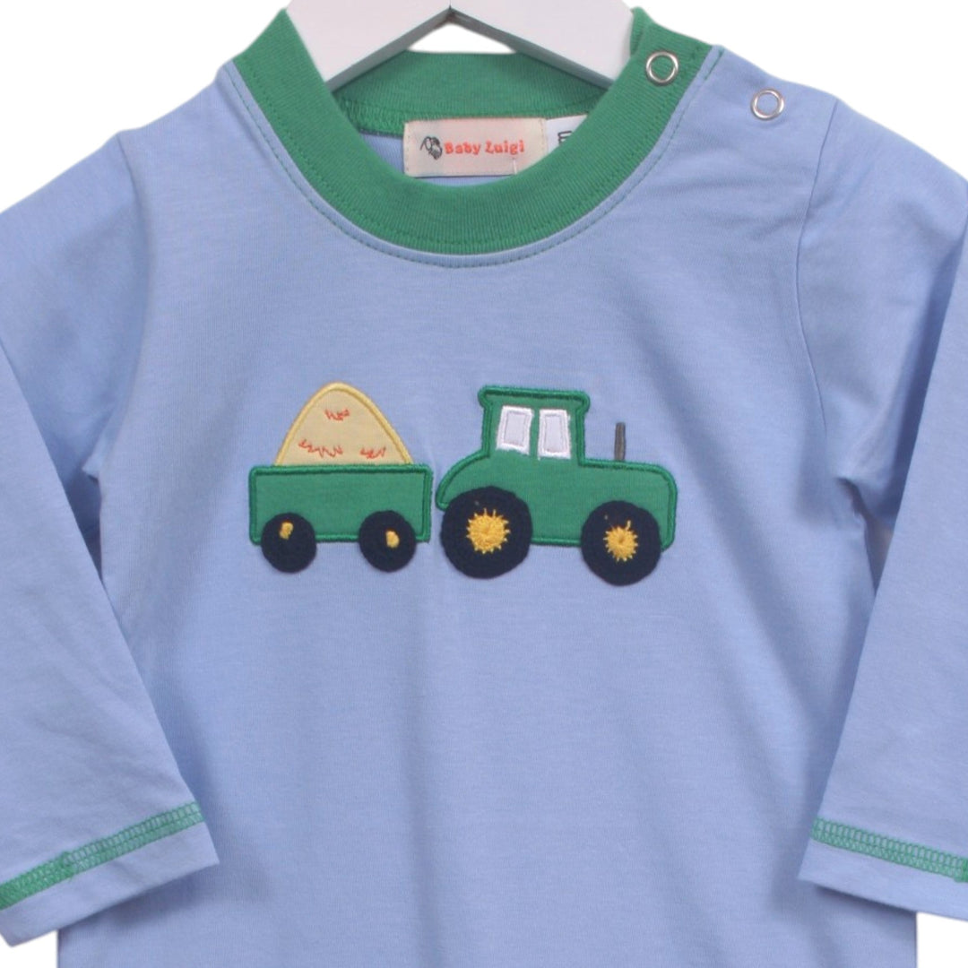 That Store blue cotton boys romper with a green tractor and hay baler applique and green trim detail