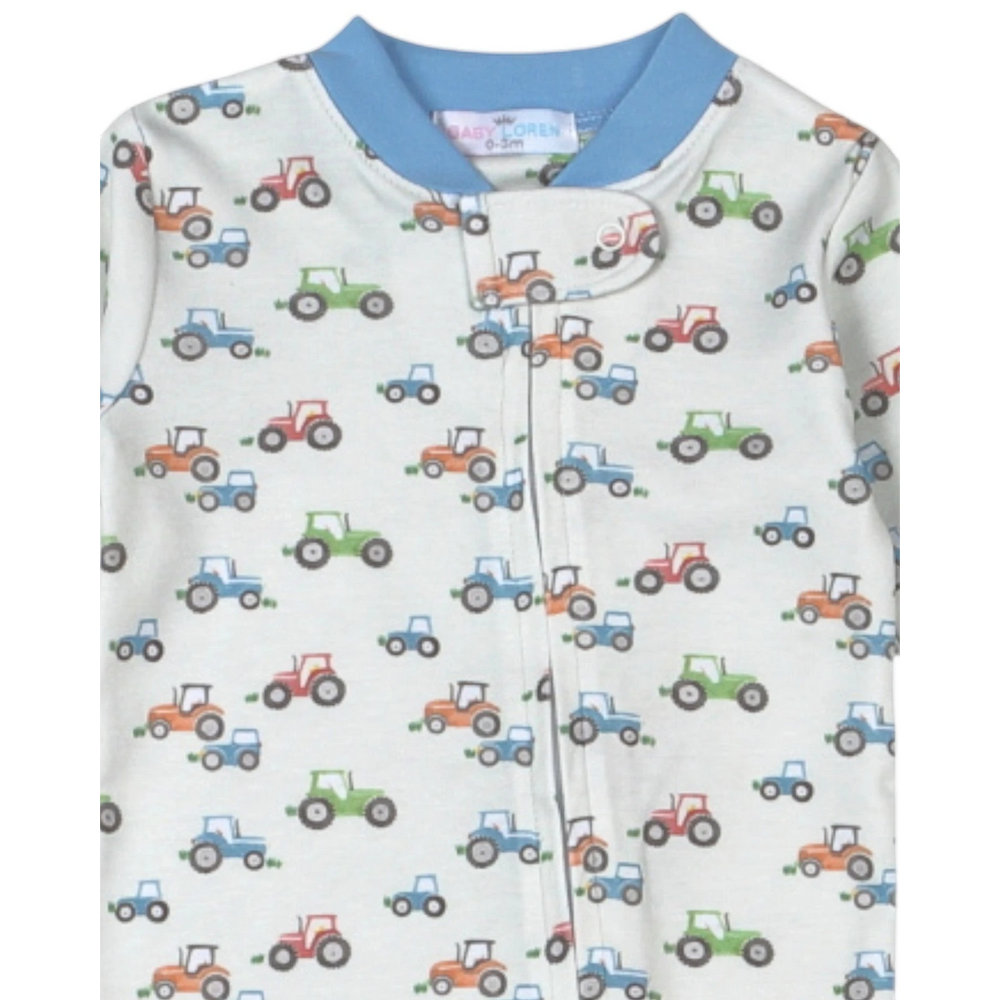 That Store baby footie pajamas in soft Pima cotton with a blue, green, and orange tractor print and zipper front.
