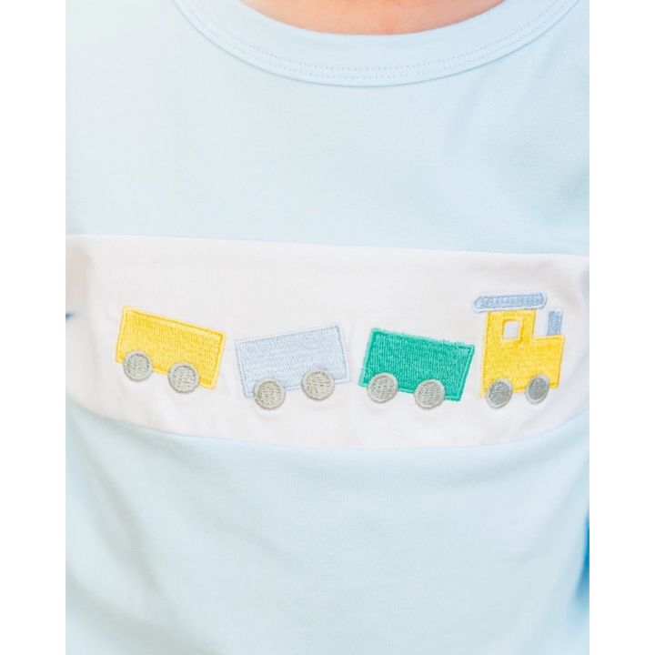 That Store boys light blue jogger set featuring a white chest panel with a colorful embroidered train motif