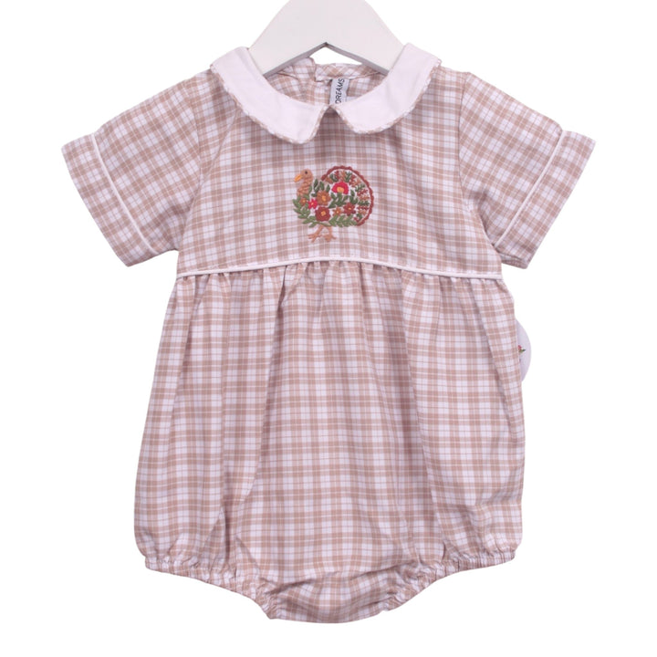 That Store beige plaid baby bubble with a white Peter Pan collar and festive turkey embroidery for Thanksgiving.