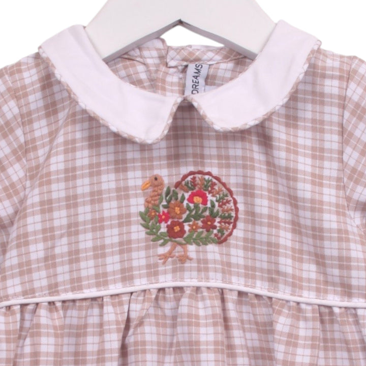 That Store beige and white plaid baby bubble with a white Peter Pan collar and festive turkey embroidery.