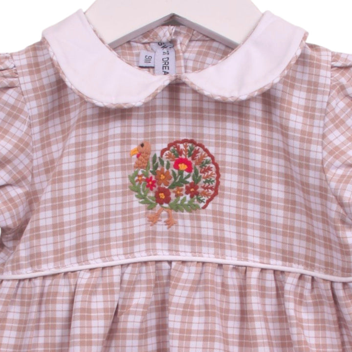 That Store girls beige plaid bubble featuring a white Peter Pan collar and a festive turkey embroidery on the bodice.