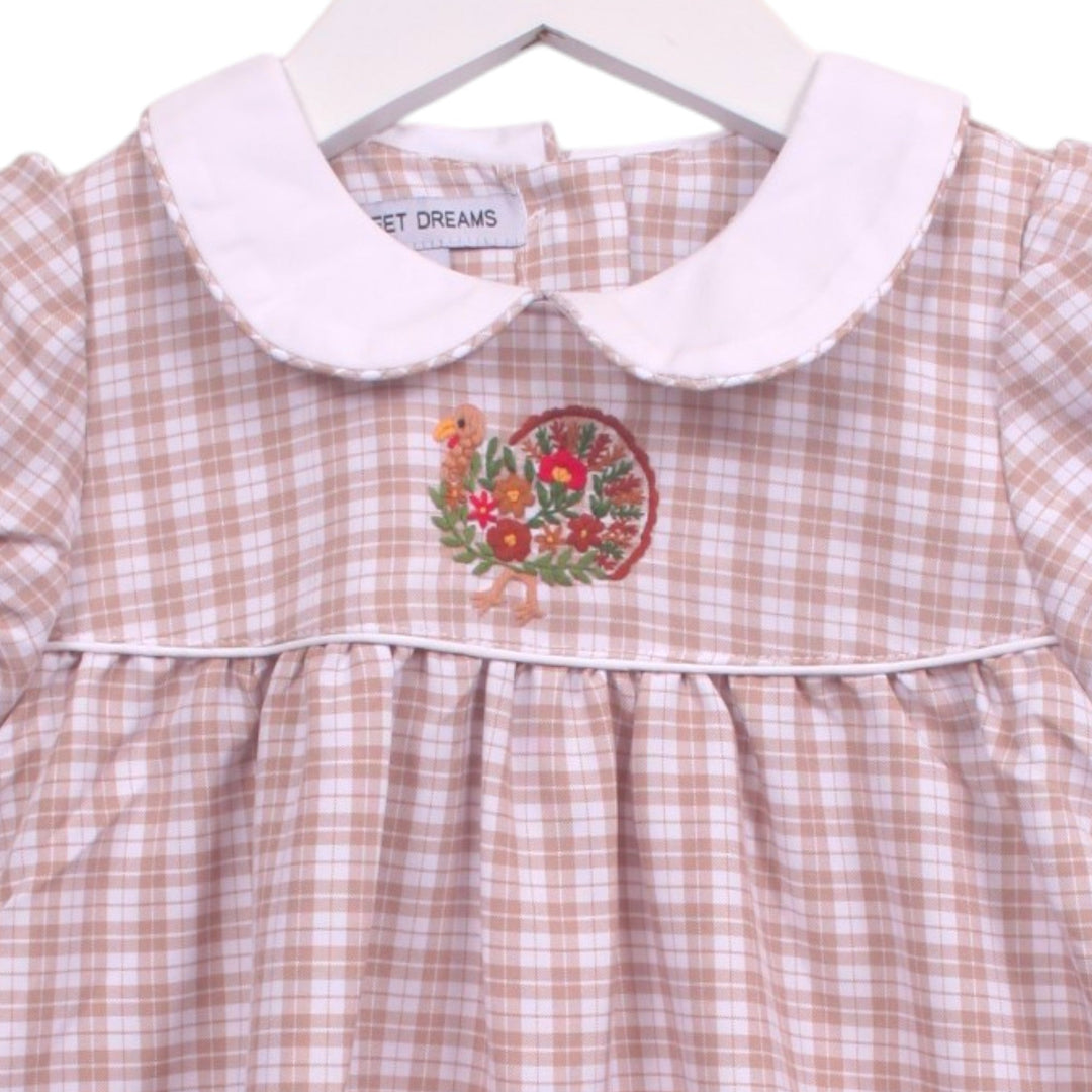That Store beige plaid toddler dress with white Peter Pan collar and festive turkey embroidery on the bodice