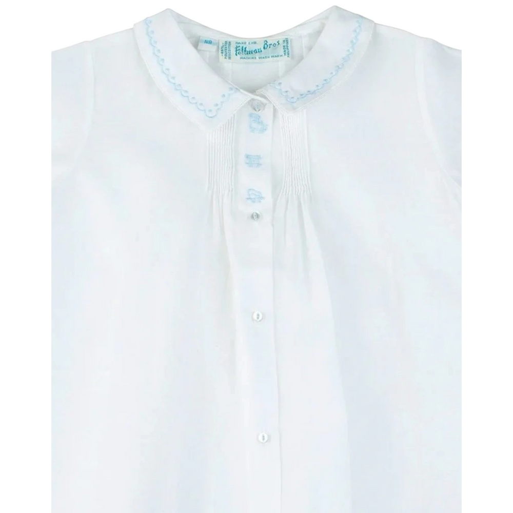 That Store white baby boy daygown with blue train embroidery, pintuck details, and a peter pan collar.