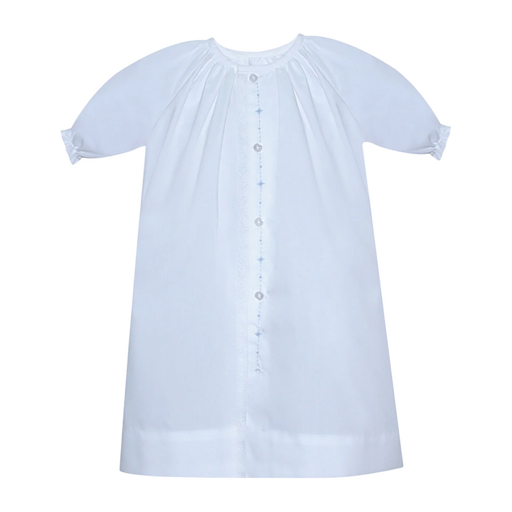 That Store white newborn baby boy daygown with blue diamond embroidery and delicate lace trim detail.