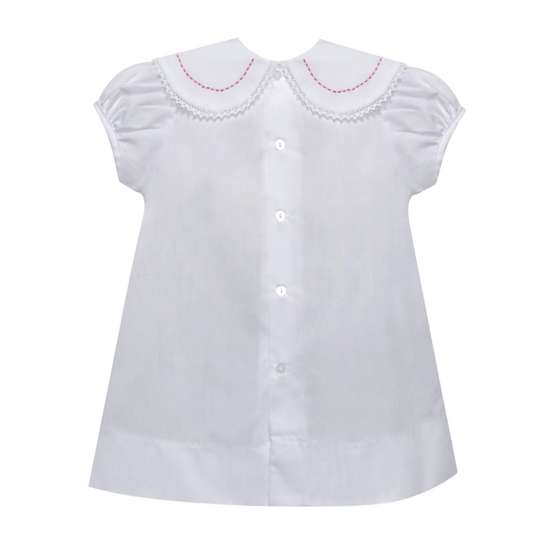 That Store white holiday dress with red candy cane embroidery, lace-trimmed round collar, and button-down front.