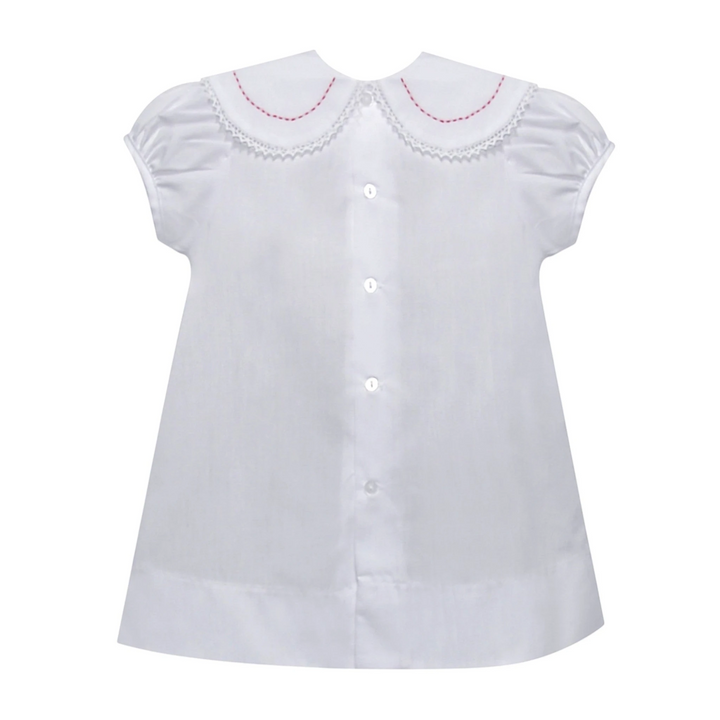 That Store white holiday dress with red candy cane embroidery, lace-trimmed round collar, and button-down front.
