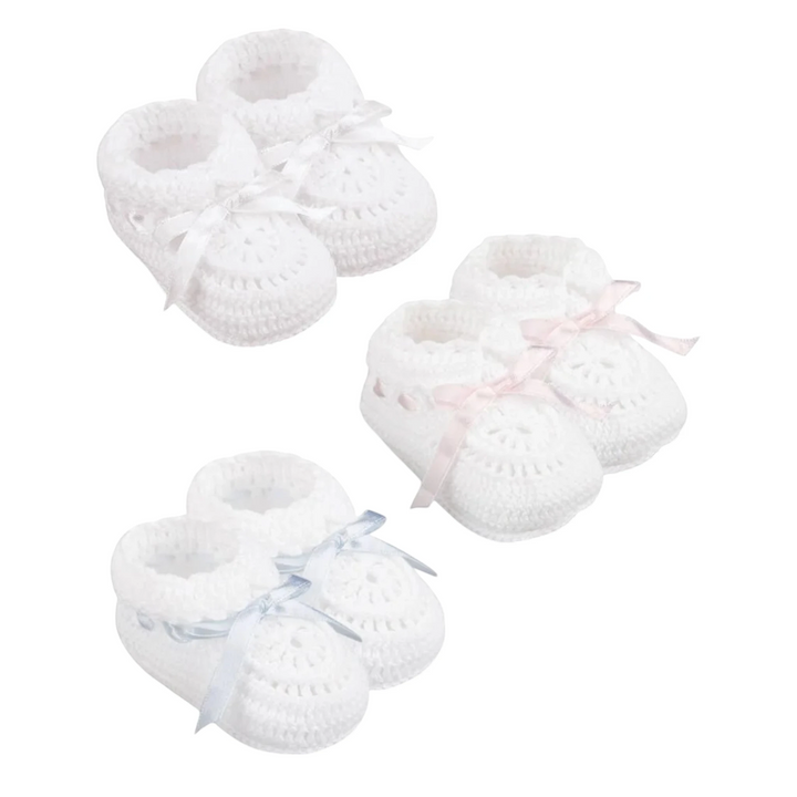 That Store white hand crocheted newborn cotton booties with adjustable satin ribbons in pink, blue, and white.
