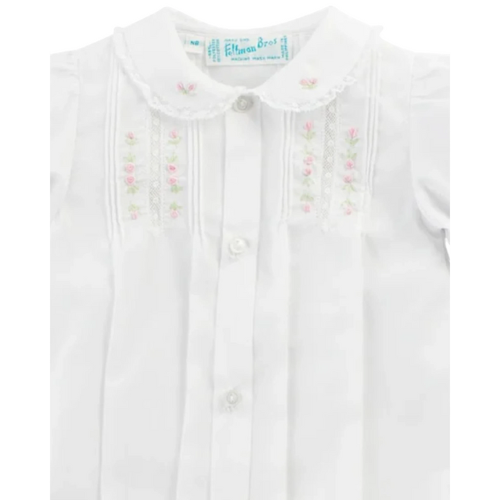 That Store baby girl white gown with pink floral embroidery, lace collar, pintucks, and button-down front.