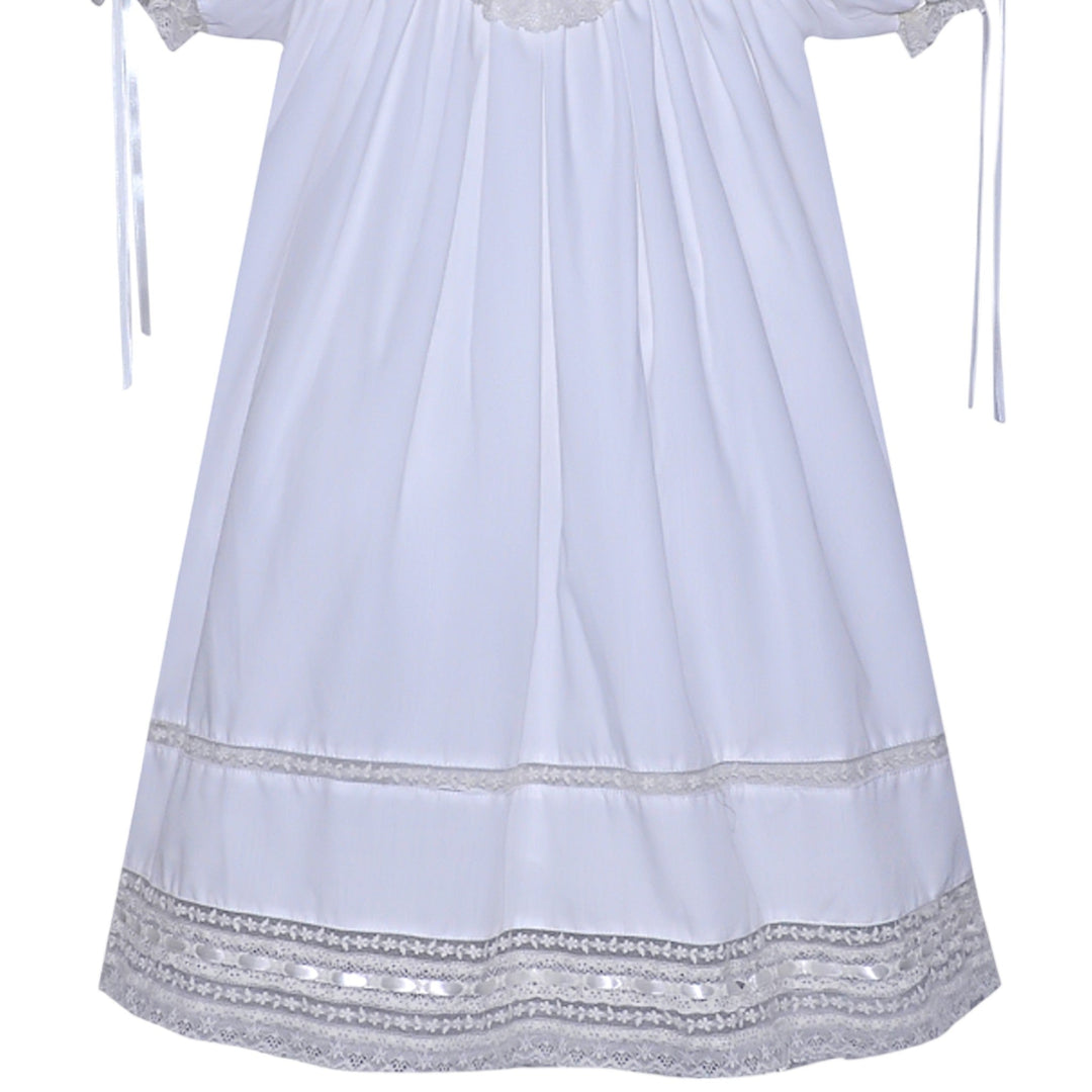 That Store white heirloom dress with ecru lace trim, puff sleeves, and ribbon details for special occasions.