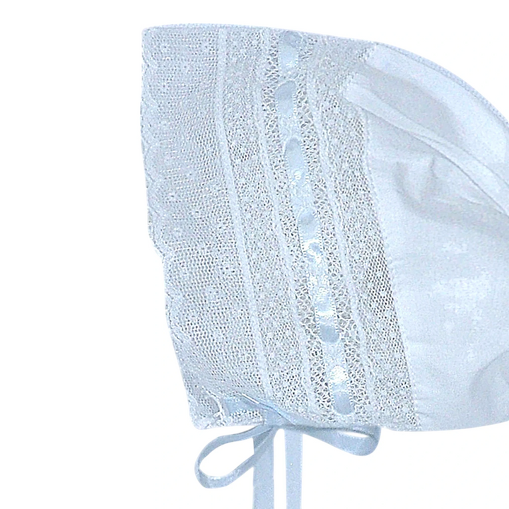 That Store white cotton baby bonnet featuring delicate lace trim and ribbon detailing for newborn girls