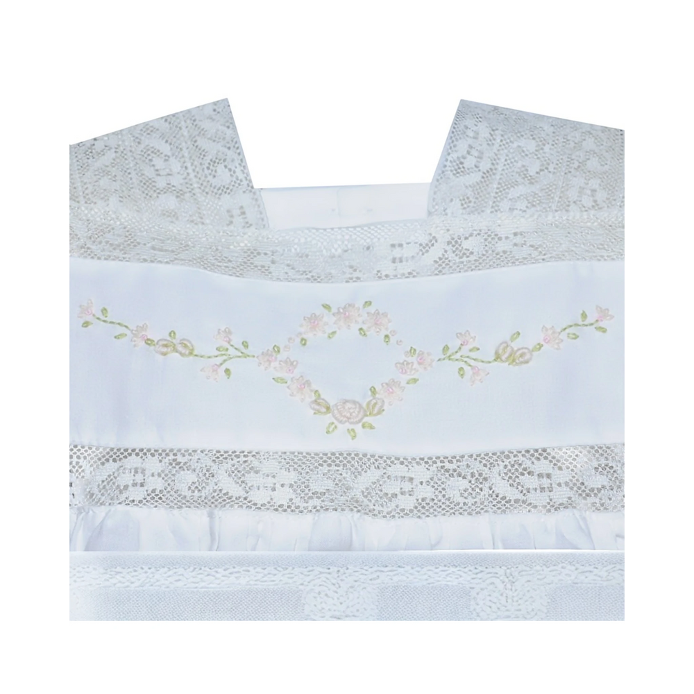 That Store white cotton heirloom dress featuring intricate lace trim and delicate floral embroidery on the bodice.