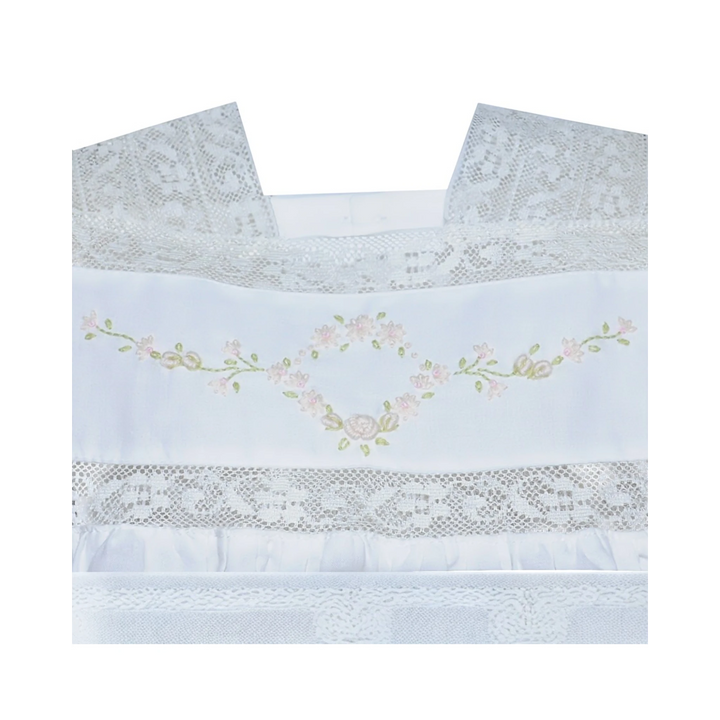 That Store white cotton heirloom dress featuring intricate lace trim and delicate floral embroidery on the bodice.