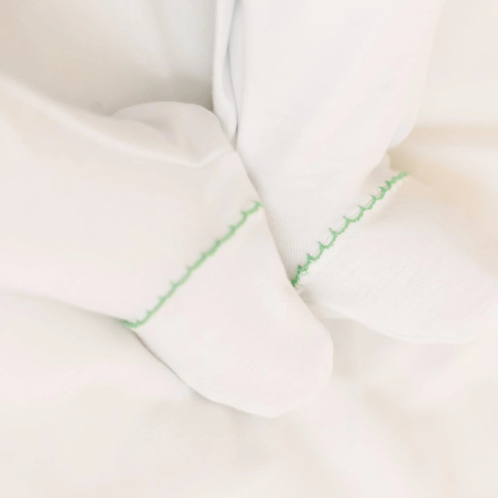 That Store white Peruvian Pima cotton baby footie with green decorative stitching detail on the feet