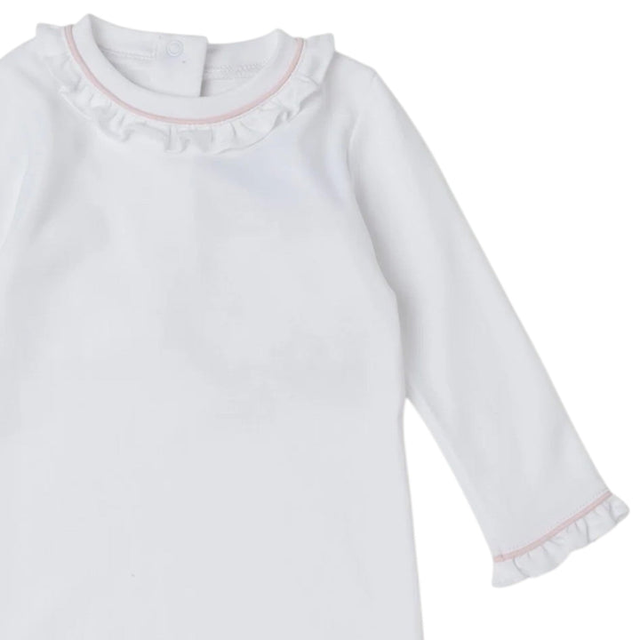 That Store white Pima cotton baby daygown with light pink piping, ruffled collar, and ruffled sleeve cuffs.