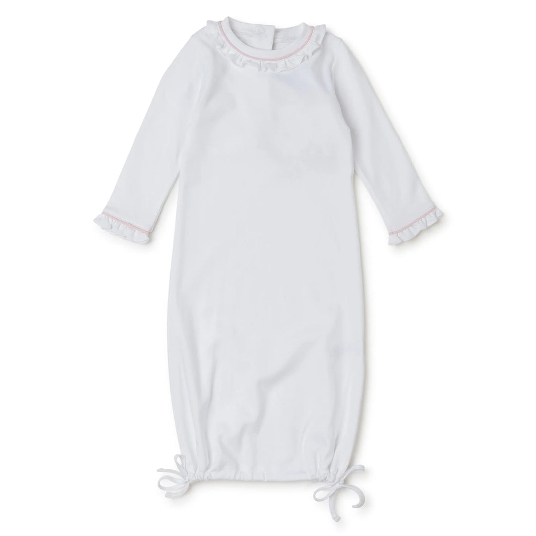 That Store white Pima cotton baby daygown with light pink piping, ruffled collar, and adjustable tie-bottom hem.