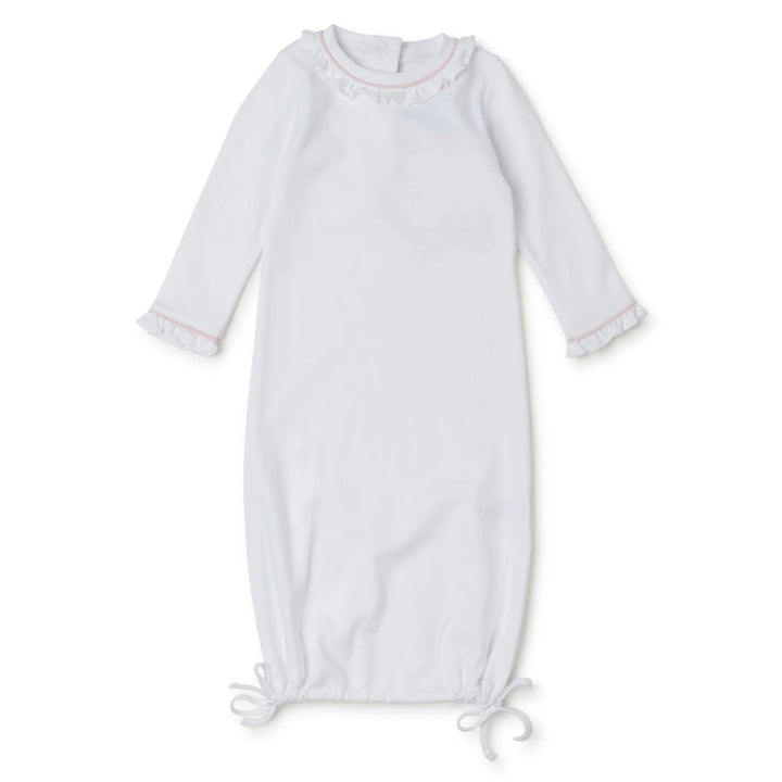 That Store white Pima cotton baby daygown with light pink piping, ruffled collar, and adjustable tie-bottom hem.