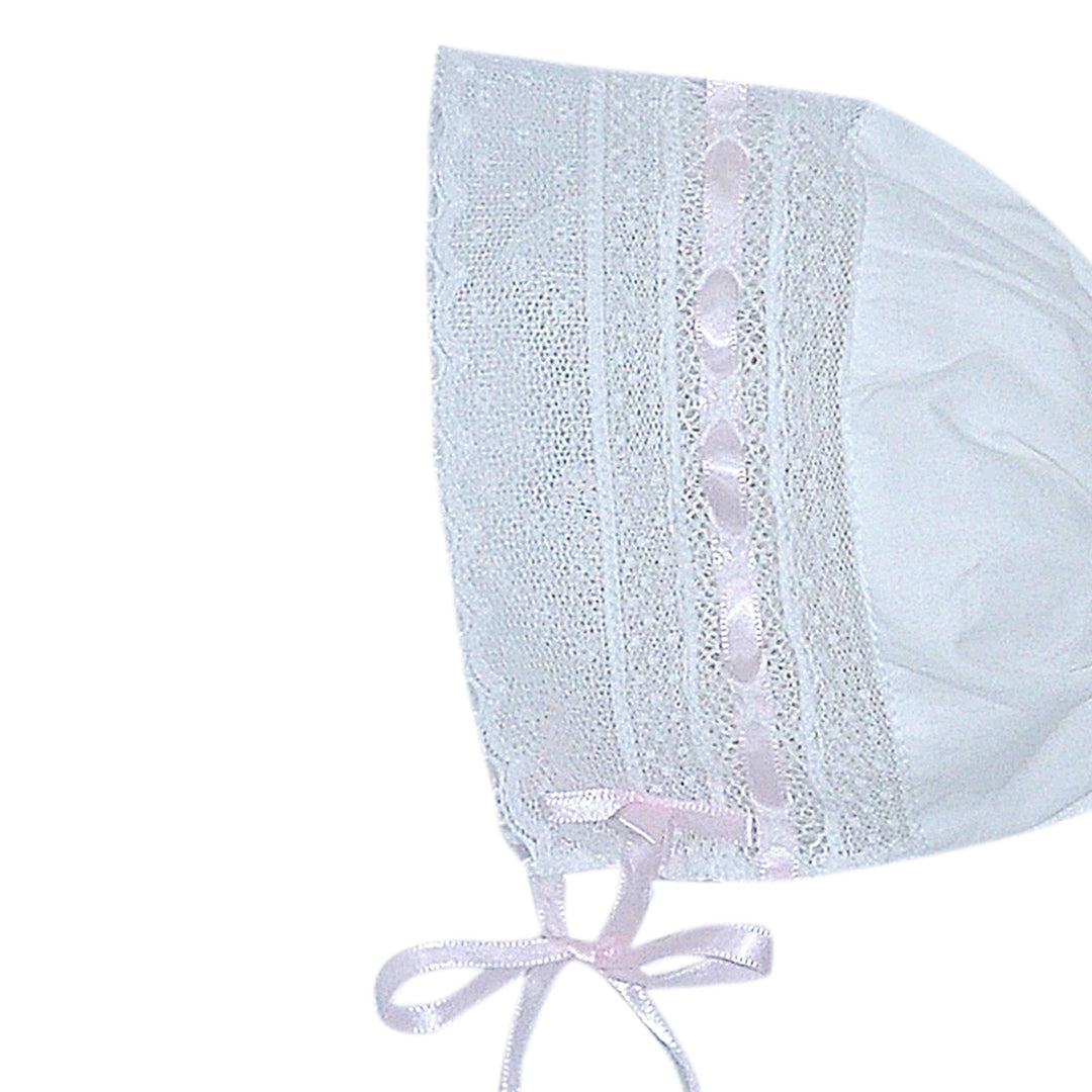 That Store white baby bonnet with delicate pink ribbon and intricate lace trim for a classic heirloom look.