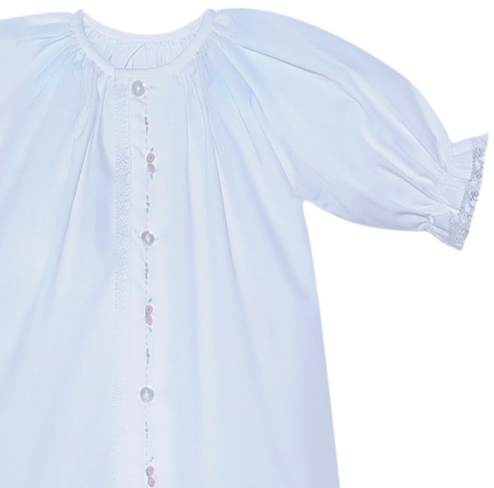 That Store white baby daygown with pink rosebud embroidery, puff sleeves, and lace trim detail.