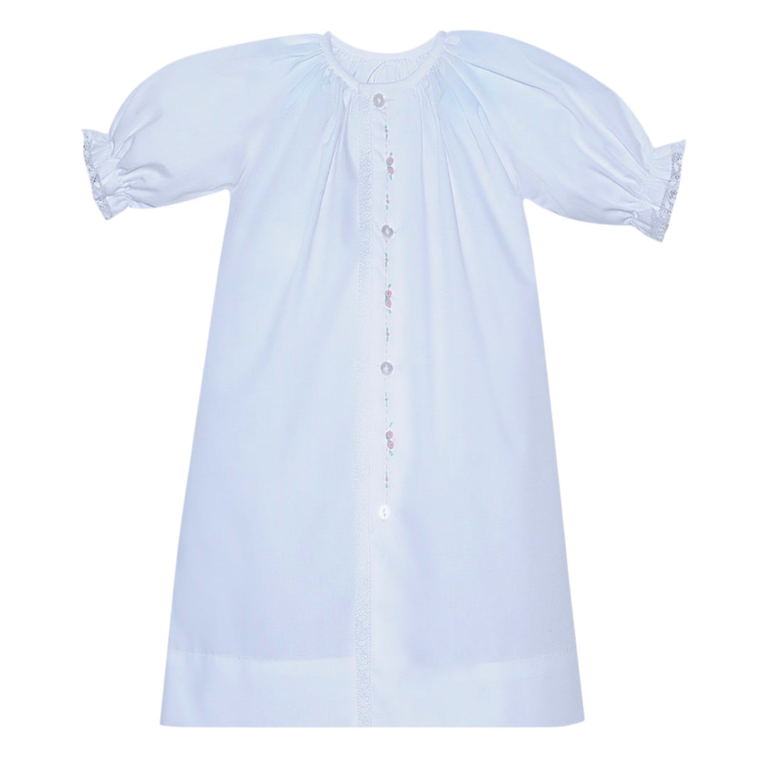 That Store white baby daygown with puff sleeves, lace trim, and delicate pink rosebud embroidery on the front placket.