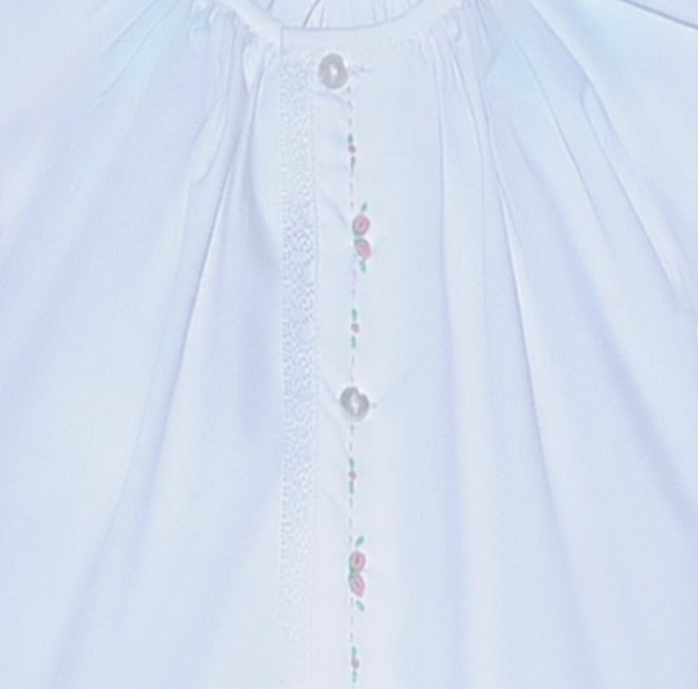 That Store white baby daygown with pink embroidered rosebuds, puff sleeves, and lace trim on the center placket.