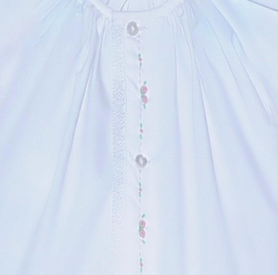 That Store white baby daygown with pink embroidered rosebuds, puff sleeves, and lace trim on the center placket.