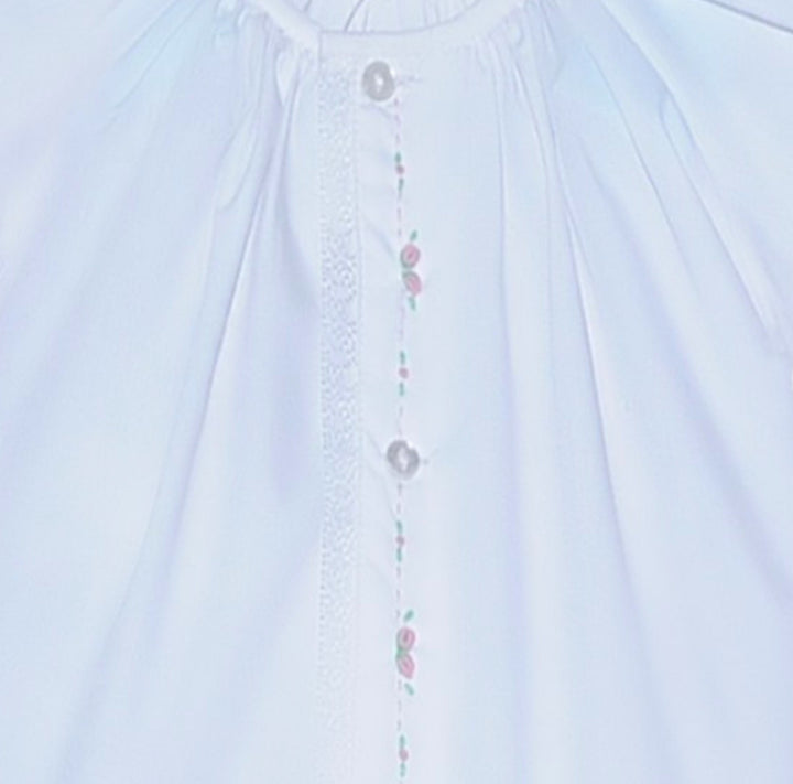 That Store white baby daygown with pink embroidered rosebuds, puff sleeves, and lace trim on the center placket.