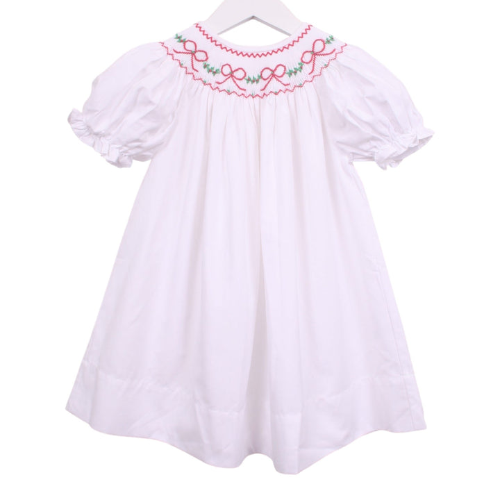 That Store white bishop dress with smocked neckline featuring red bows and green garland embroidery