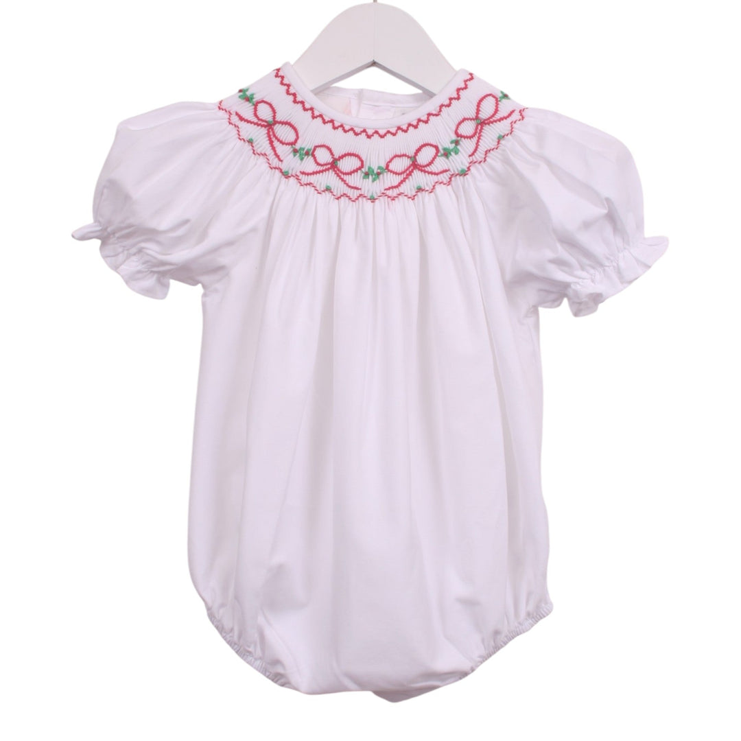 That Store white girls bubble with smocked neckline featuring red bows and green garland, puff sleeves, and ruffles.