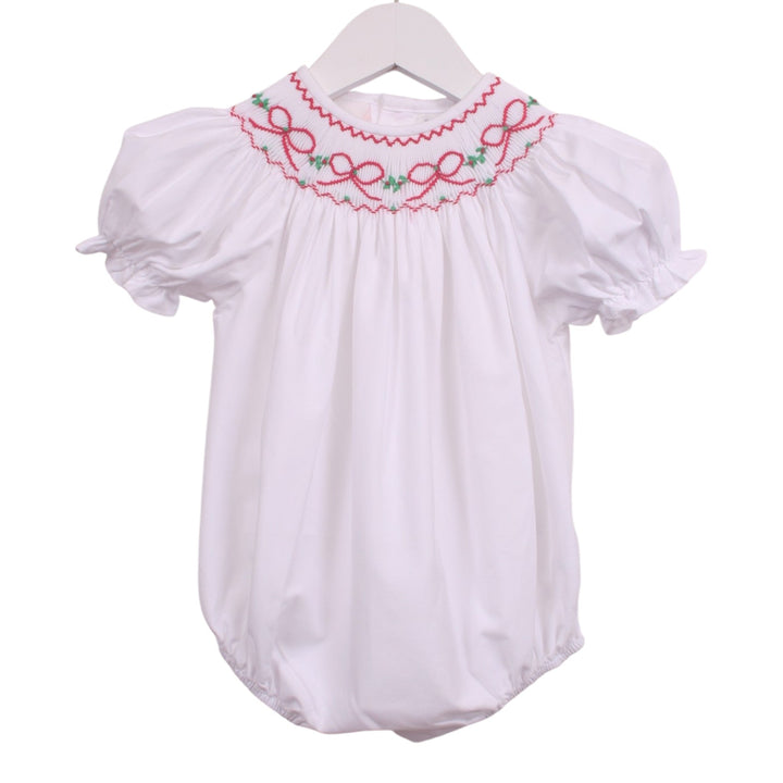 That Store white girls bubble with smocked neckline featuring red bows and green garland, puff sleeves, and ruffles.
