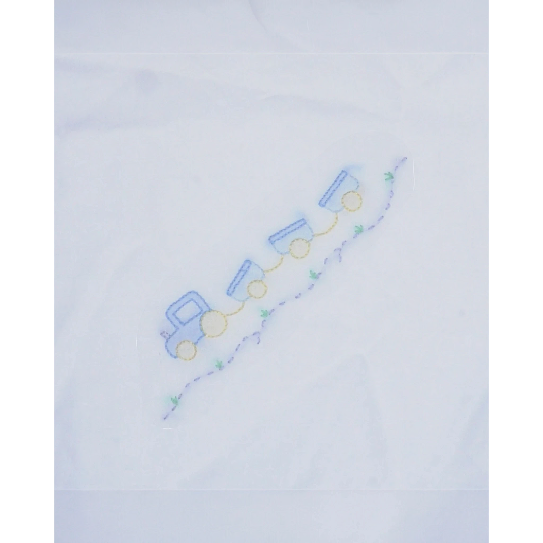 That Store white baby receiving blanket featuring a delicate blue and yellow shadow stitched train design