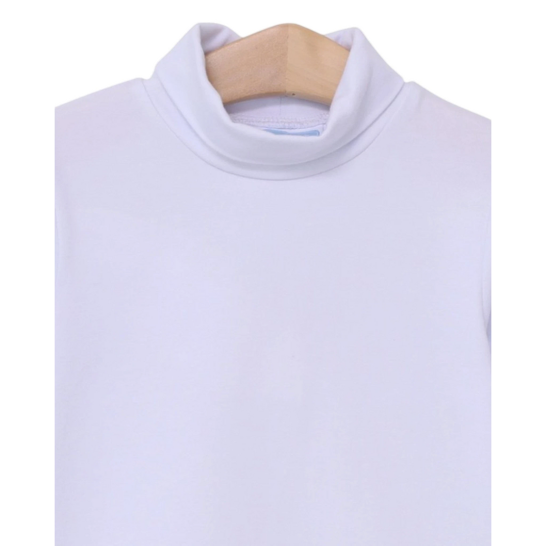 That Store white Taylor turtleneck for children made from soft cotton and spandex blend on a wooden hanger
