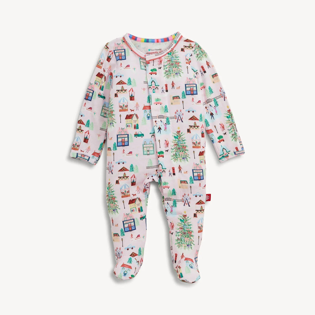 That Store baby footie in soft modal fabric featuring a festive winter village print with magnetic closures